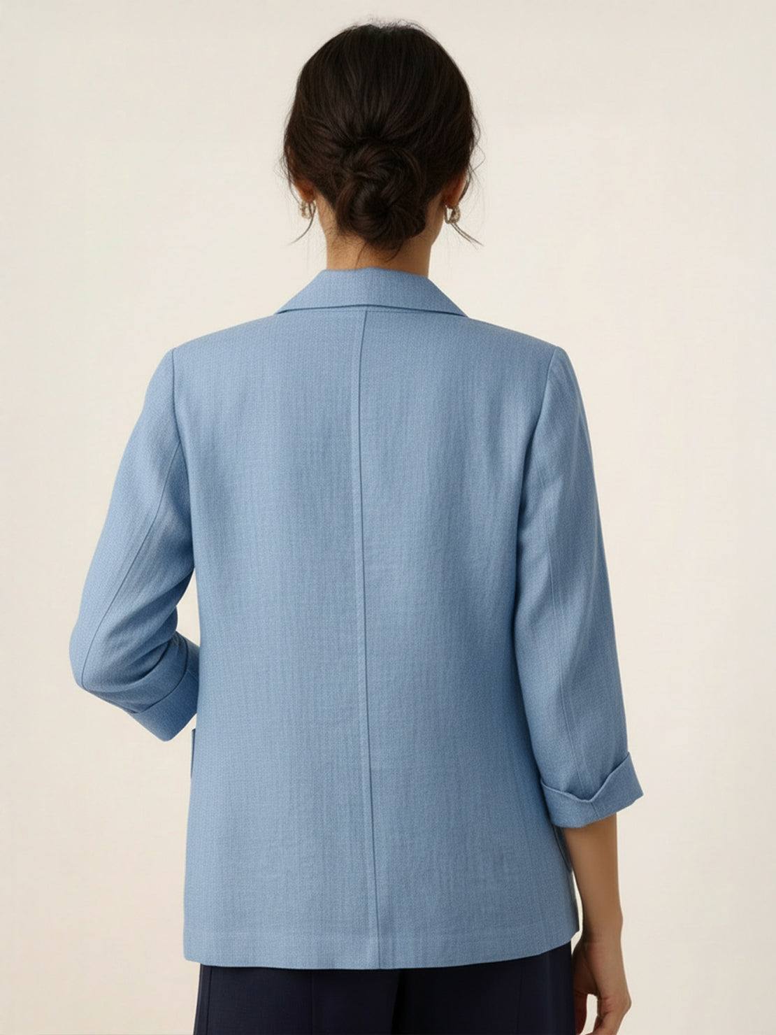 Cotton-linen blazer with notch lapels, two-button closure, patch pockets, and natural textured fabric.