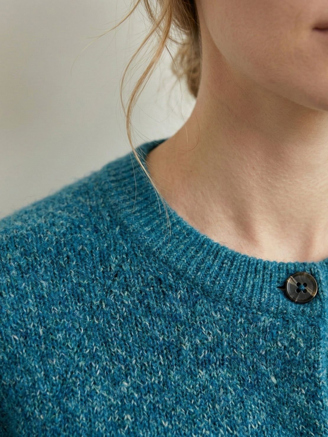 Marled knit merino wool cardigan with contrasting buttons and ribbed cuffs for a relaxed fit