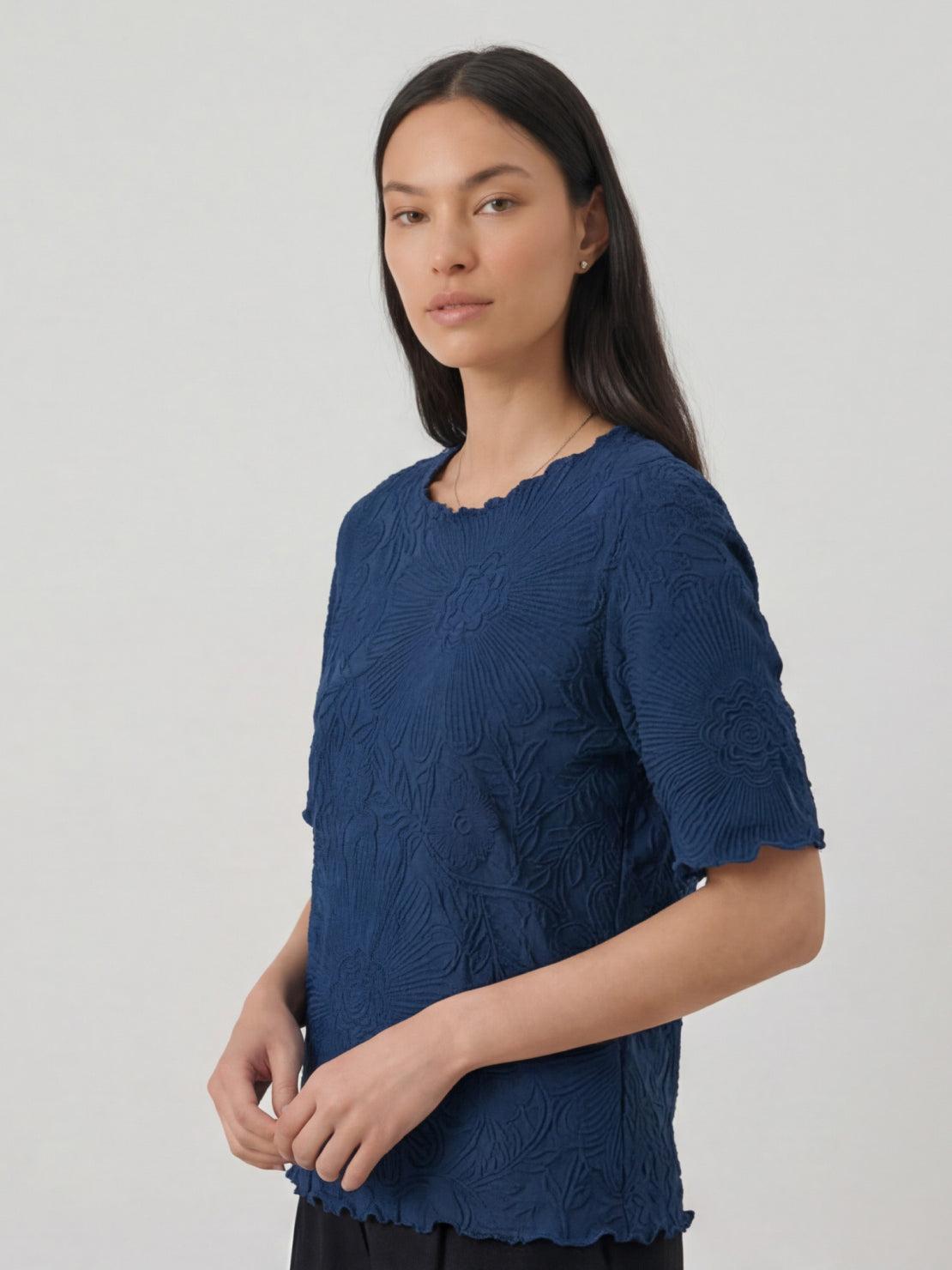 Lightweight floral jacquard pleated top with flutter sleeves and A-line silhouette