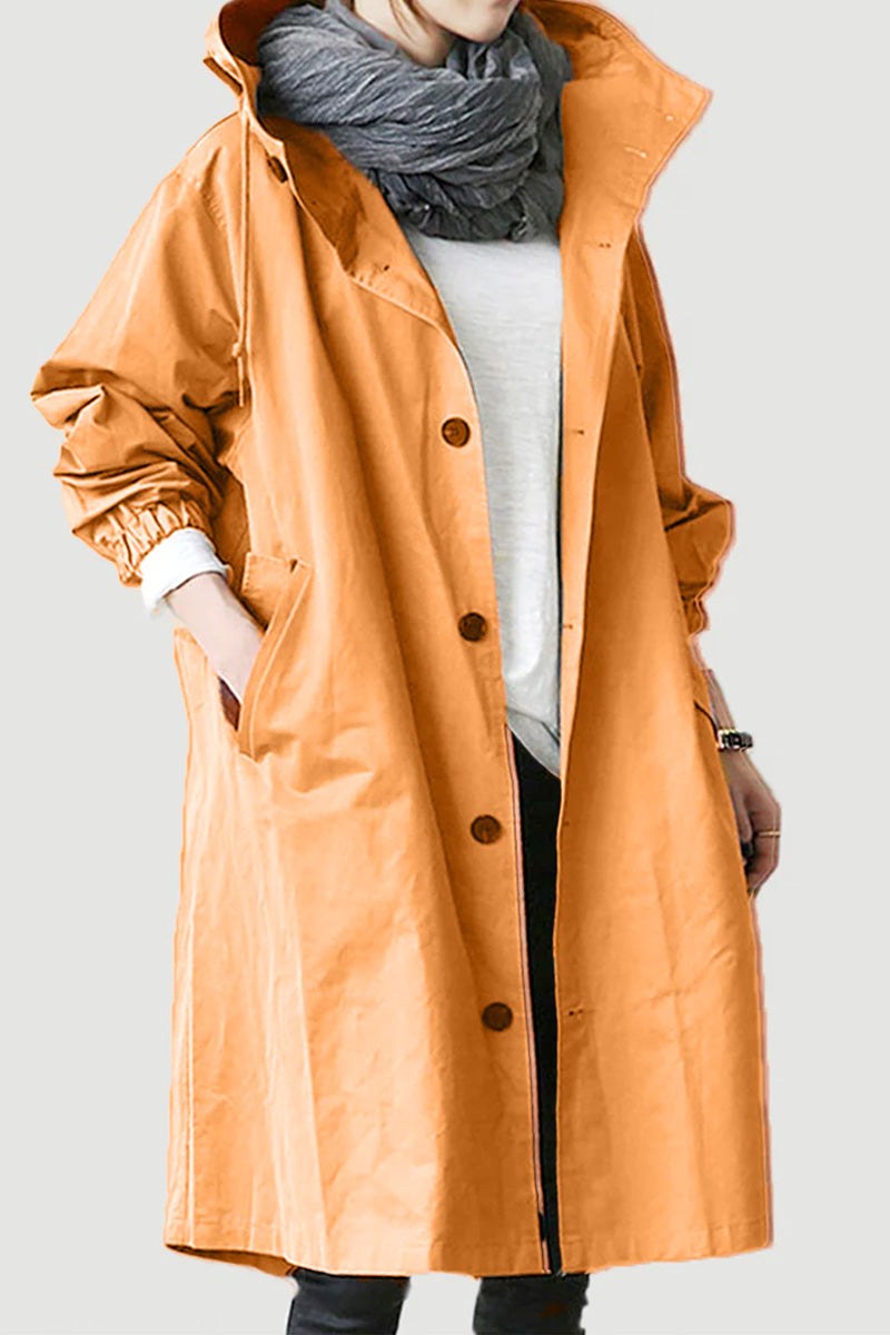 Water Resistant Oversized Windbreaker in orange with hood and button closure worn over casual outfit