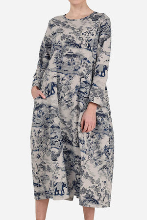 Woman wearing a loose fit Japanese Porcelain Print midi dress with 3/4 sleeves and two front pockets