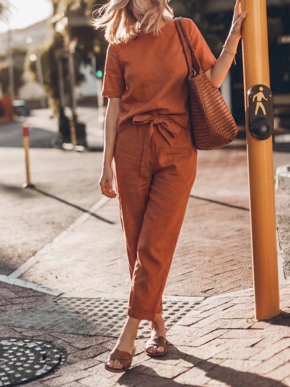Woman wearing relaxed cotton-linen set with short-sleeve top and straight-leg pants in neutral monochrome tones