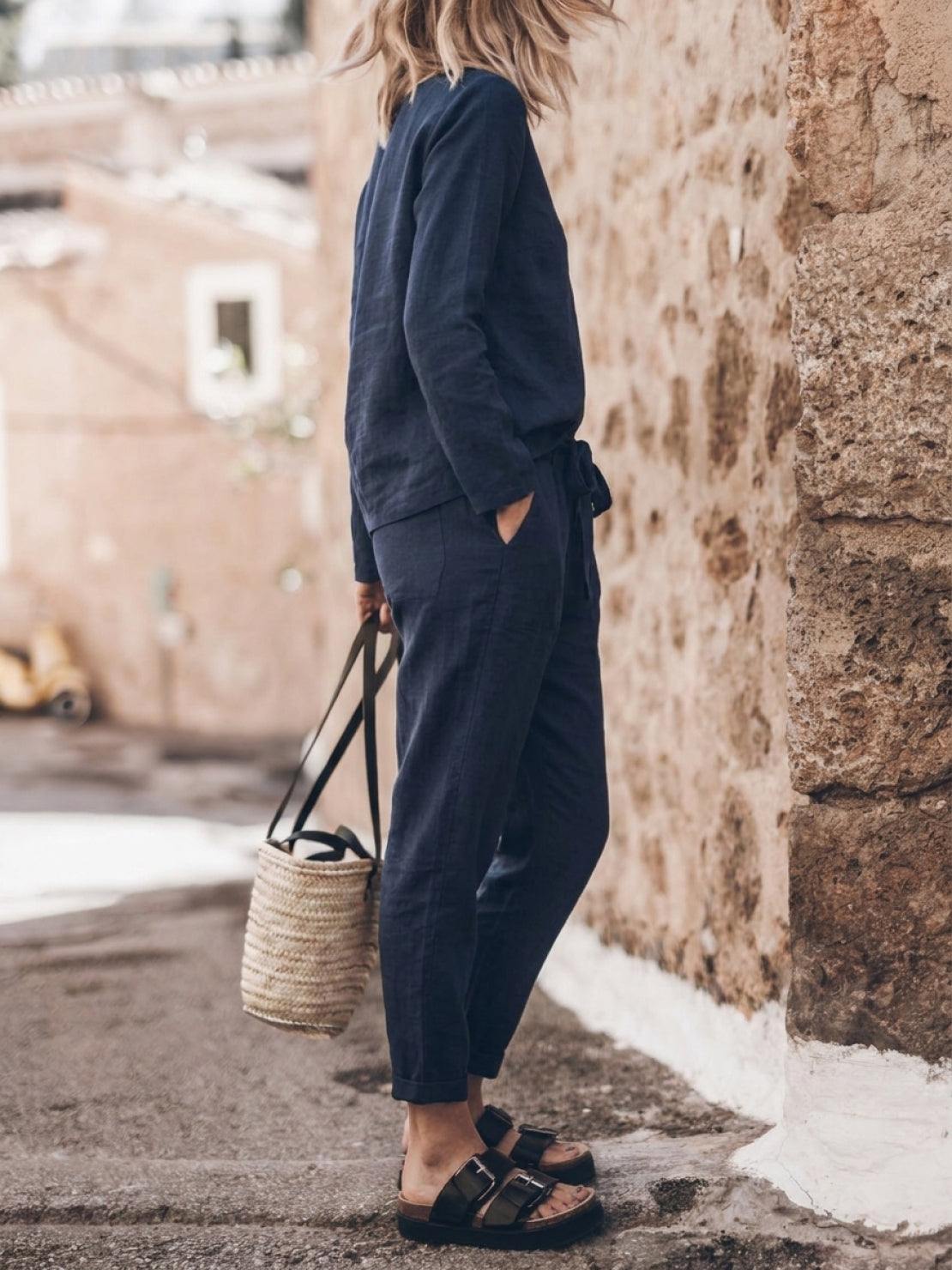Woman wearing a relaxed cotton-linen monochrome top and wide-leg pants set in neutral tones