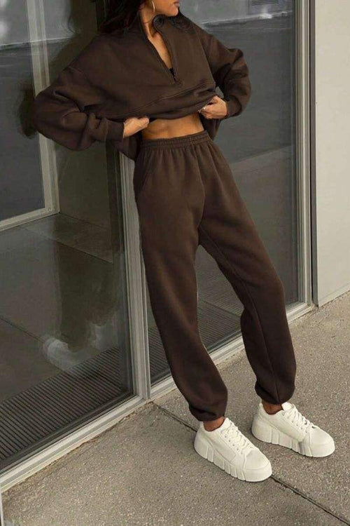 Classic Airplane Set brown cotton blend two-piece tracksuit with pullover and joggers, styled with white sneakers.