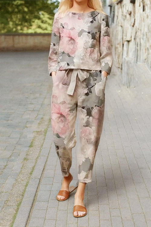 woman wearing cotton-linen monochrome floral print relaxed top and wide-leg pants set on outdoor pathway