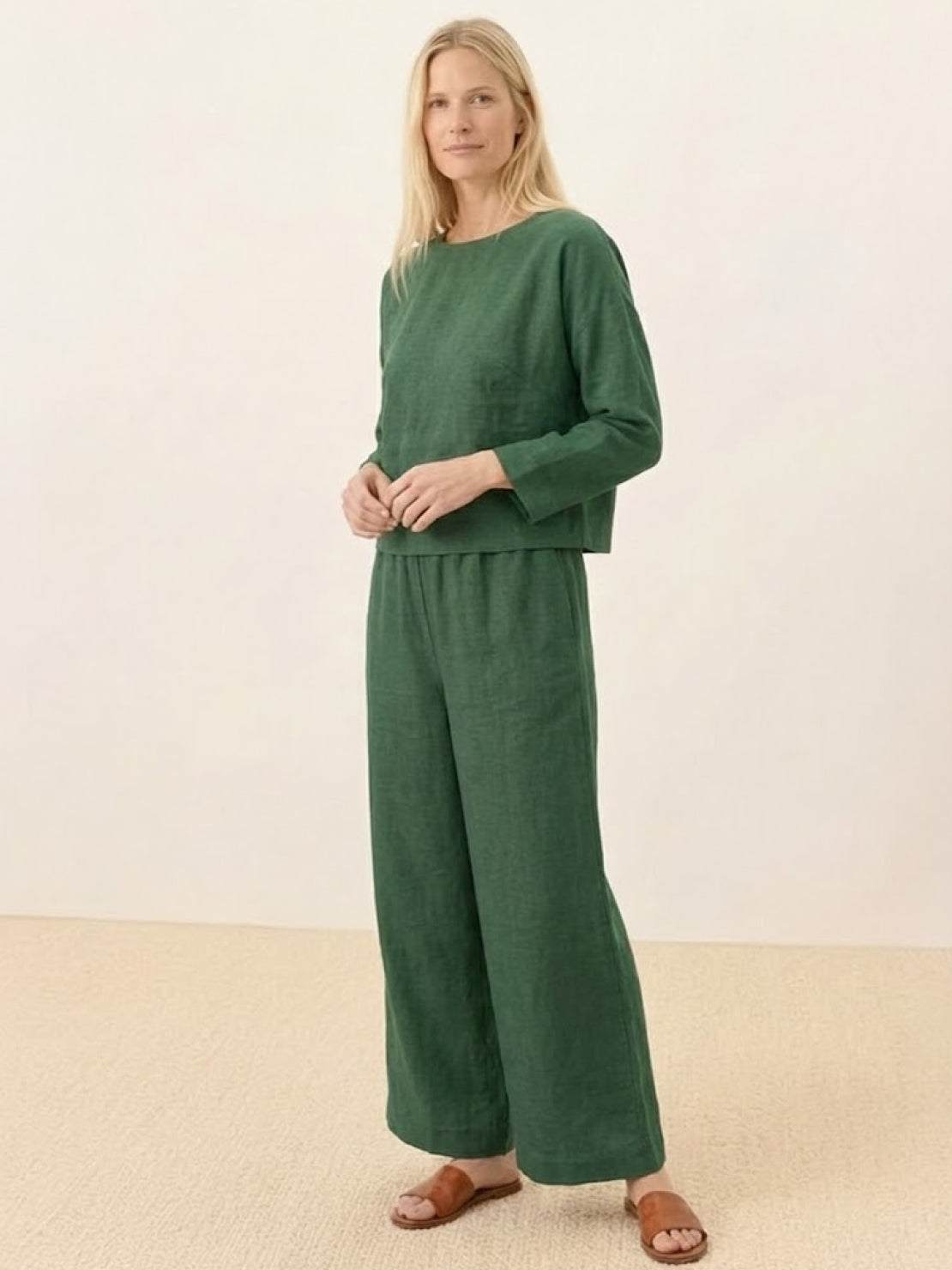 Woman wearing loose solid color two-piece set with wide-leg pants and round-neck top