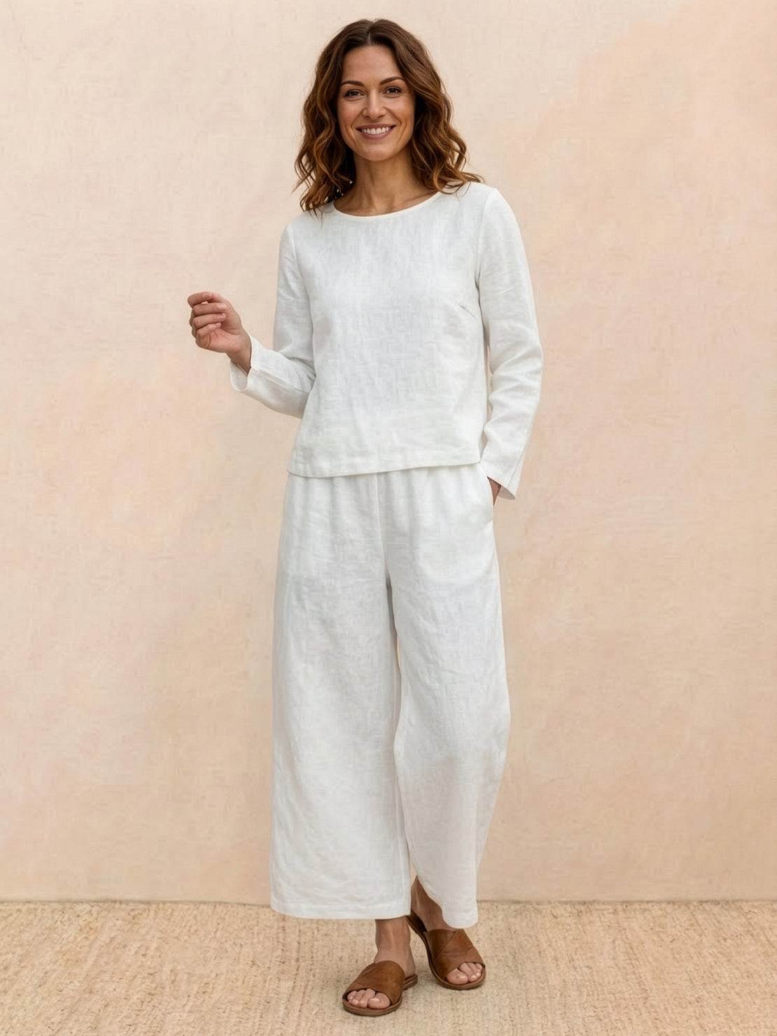 Woman wearing loose solid color two-piece set with wide-leg pants and round-neck top
