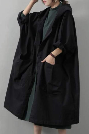 Oversized black waterproof windbreaker jacket with hood and large front pockets, one size fits all design