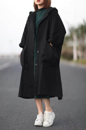Oversized black waterproof windbreaker jacket with hood and large pockets, lightweight and longline design
