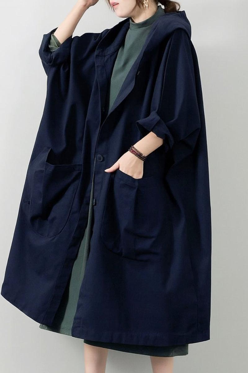 Oversized water-resistant windbreaker jacket with waterproof design, attached hood, snap-button closure, and large pockets.