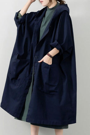 Oversized water-resistant windbreaker jacket with waterproof design, attached hood, snap-button closure, and large pockets.