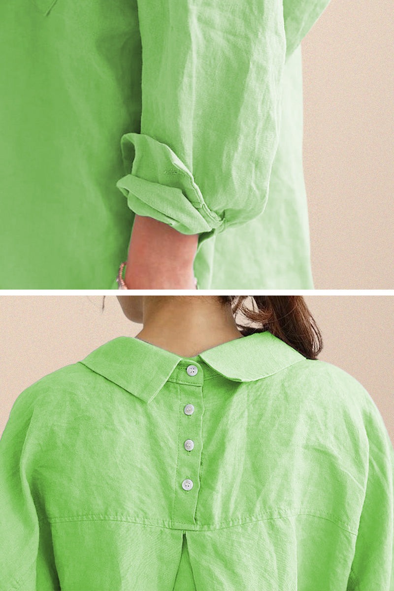 Close-up of oversized linen shirt in light green with rolled sleeves and back button detailing