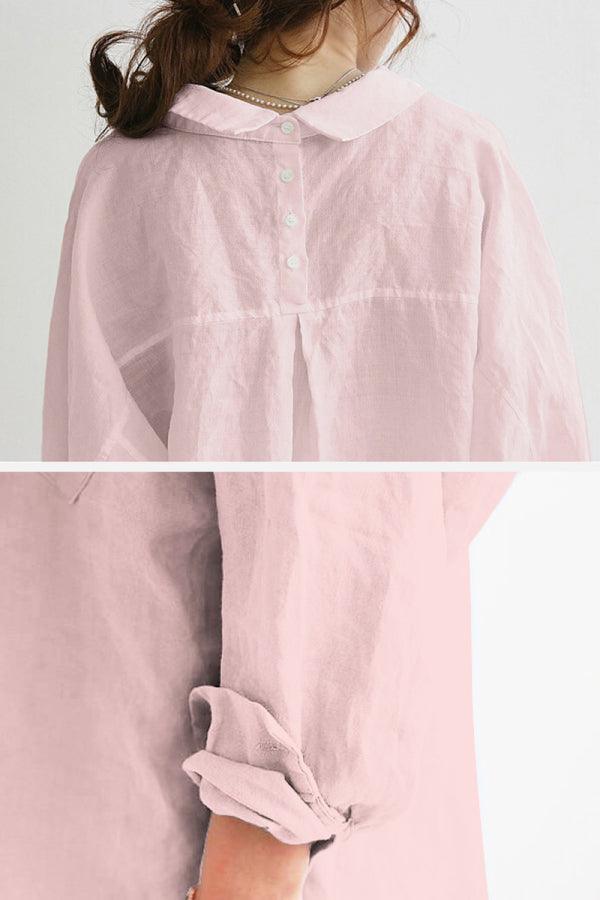 Back view of a light pink oversized linen shirt with rolled-up sleeves and buttoned collar