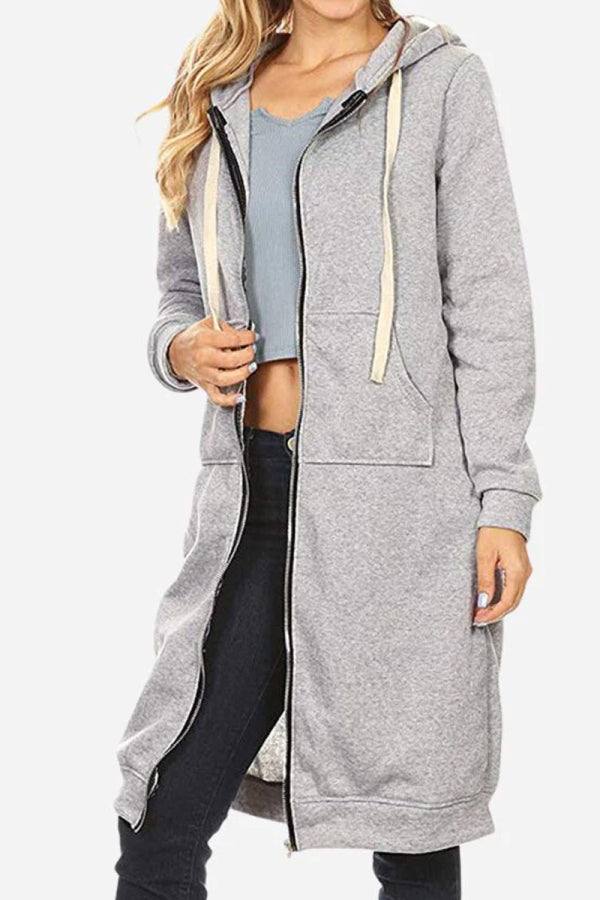 Woman wearing gray oversized long zip sweatshirt hoodie with drawstring hood and front pockets