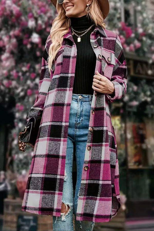 Oversized medium-length plaid overshirt in blue and pink tones worn over black top and jeans outdoors