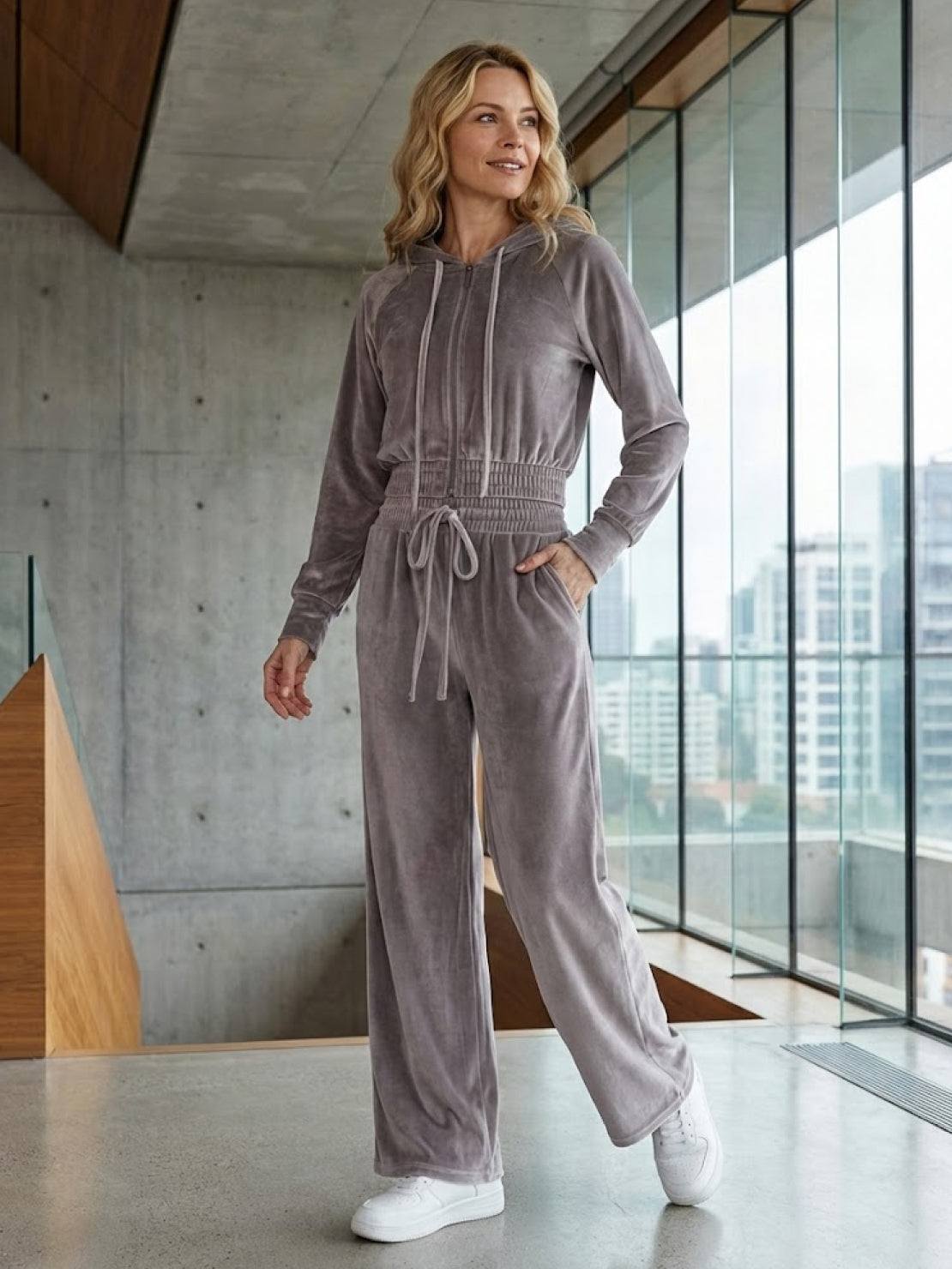 woman wearing modern cropped velour tracksuit with high-waist pants in vibrant color