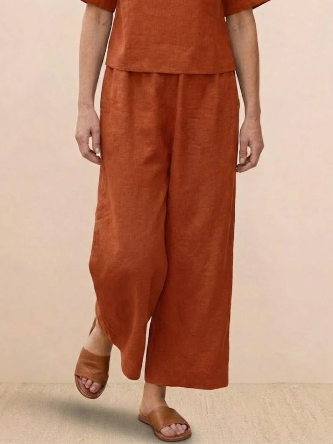 Rust-colored loose fit co-ord set with wide-leg pants and relaxed short sleeve top.