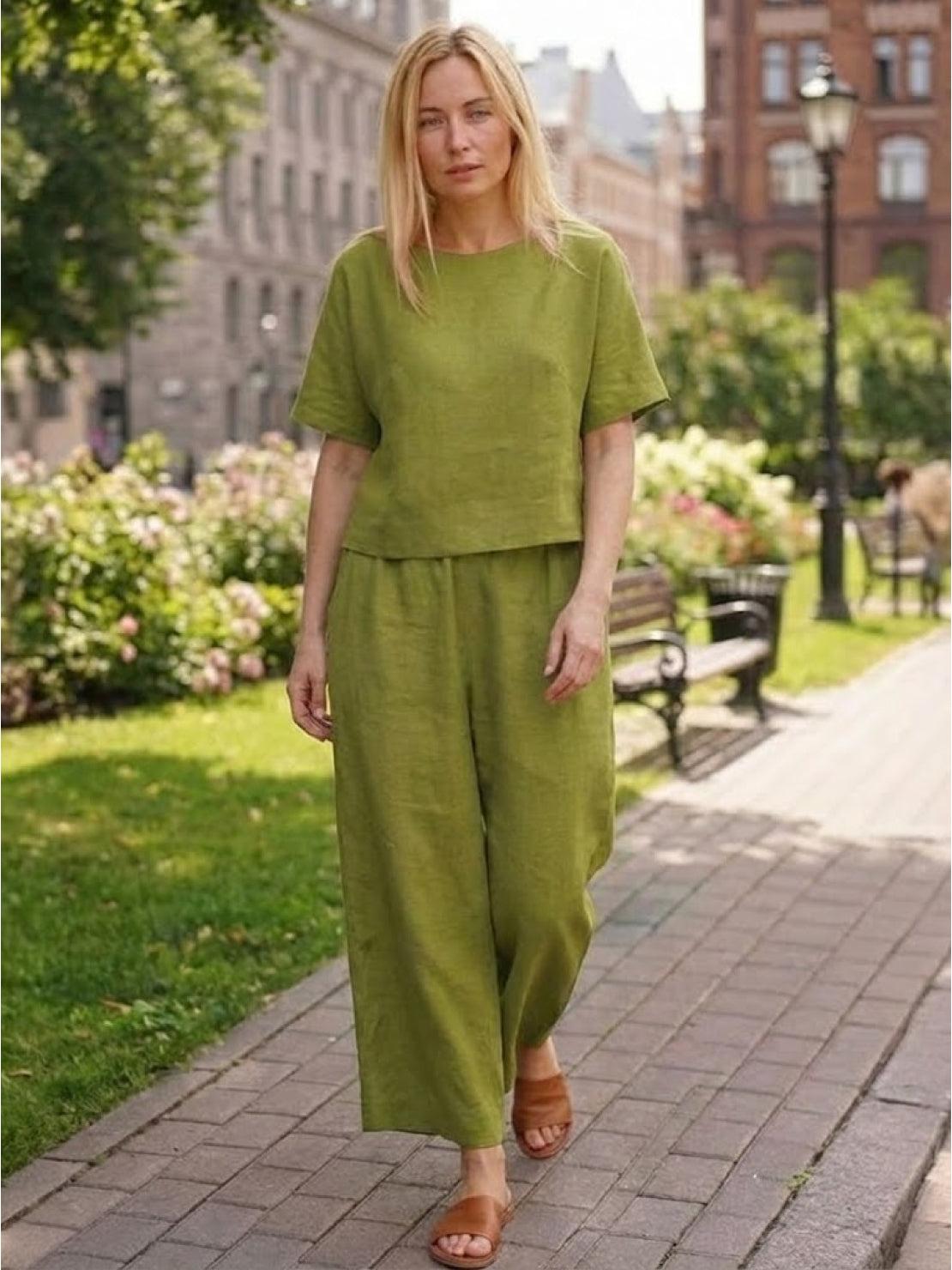 woman wearing olive green loose fit co-ord set with short sleeves and wide-leg pants walking outdoors