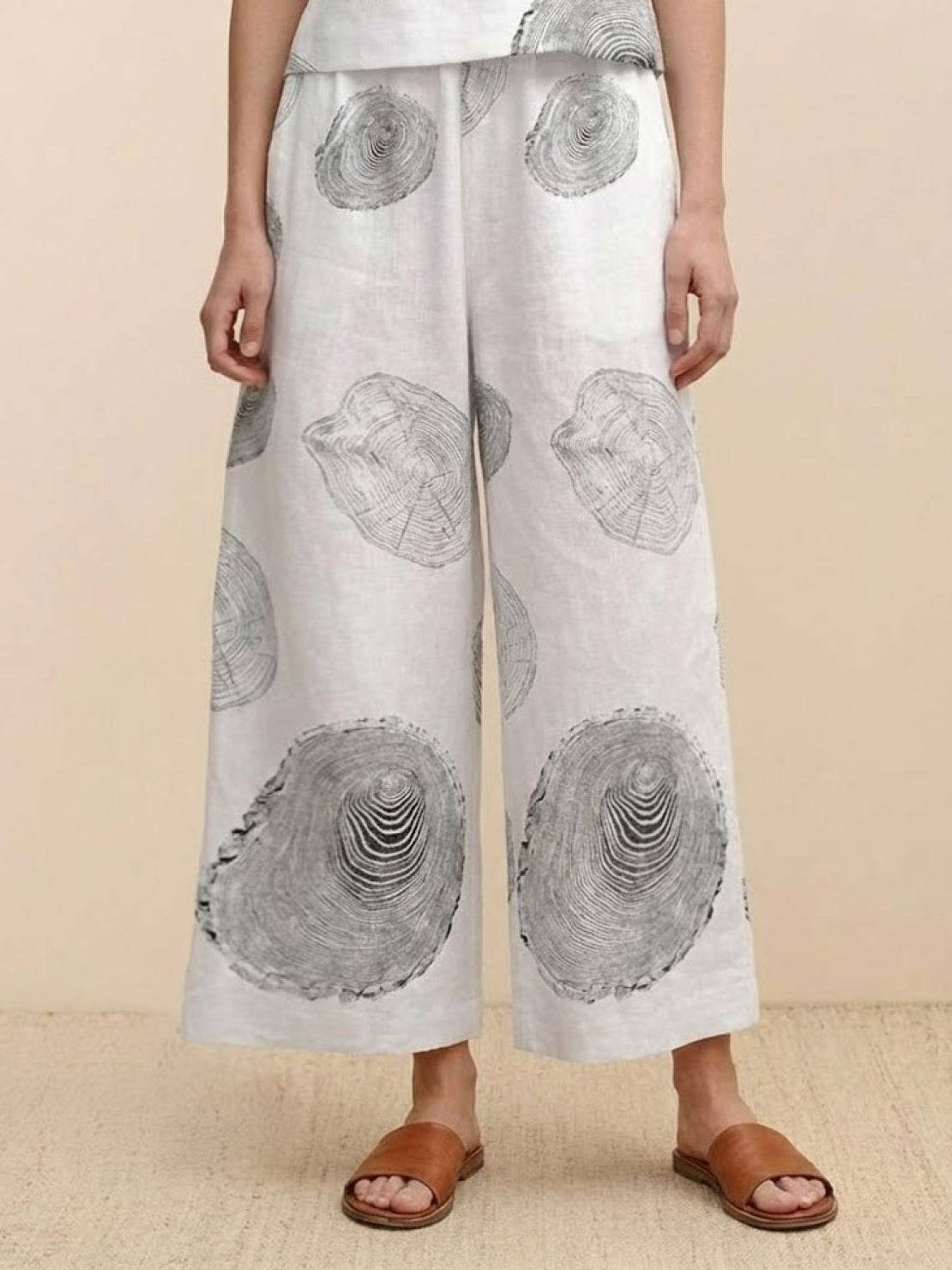 Wide-leg loose fit co-ord set trousers with large circular abstract prints and elastic waistband.
