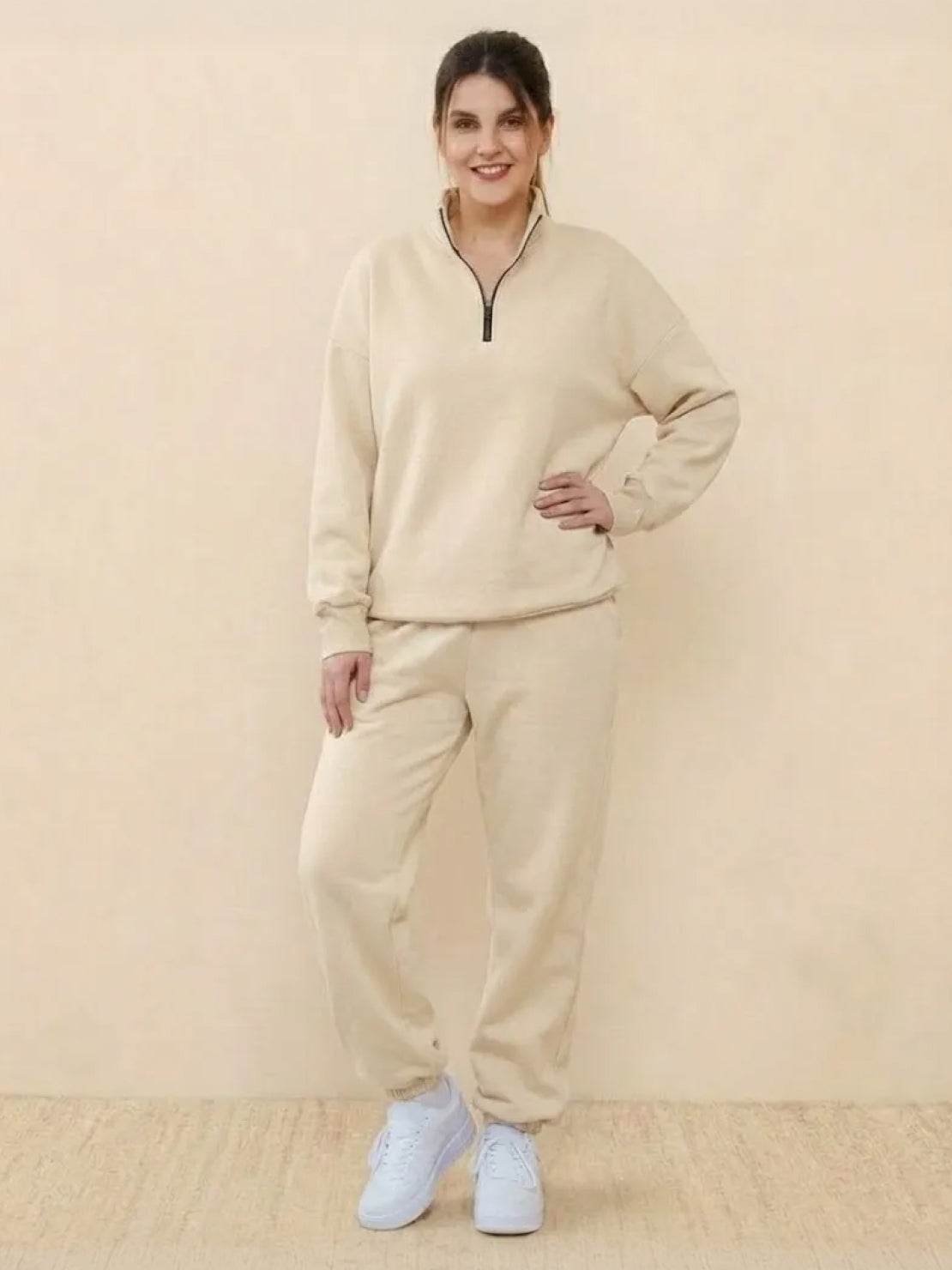 Woman wearing beige ultra-soft and comfy co-ord tracksuit set with zip-up top and relaxed pants.