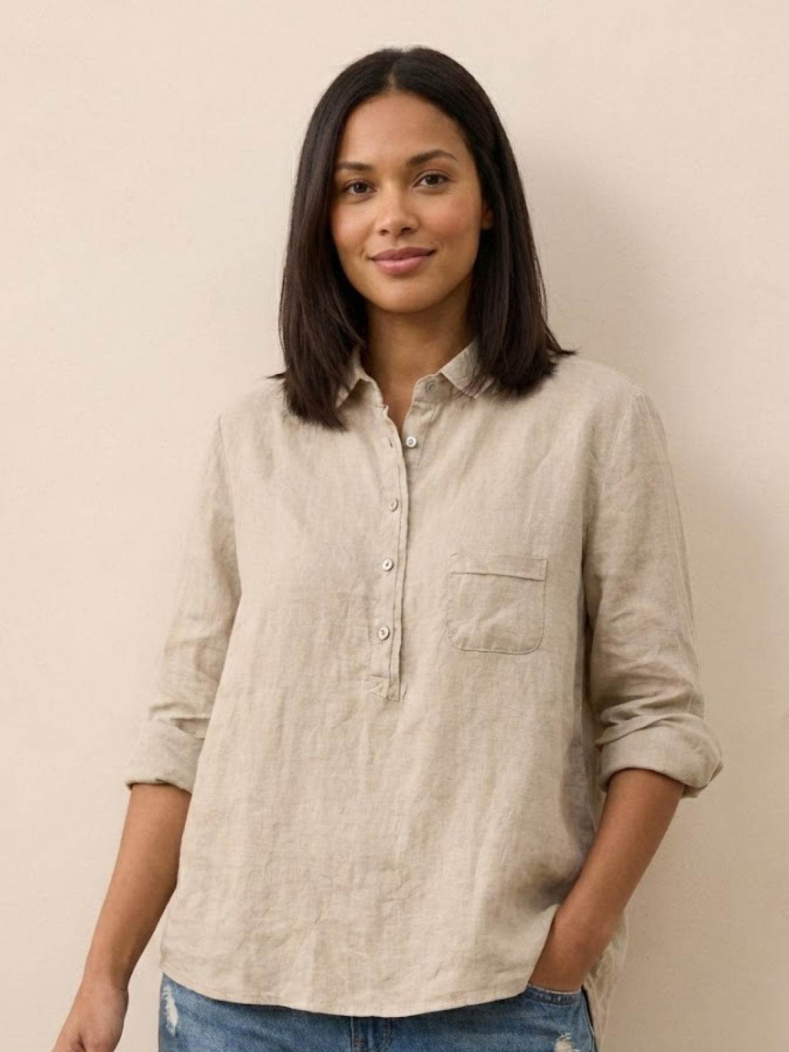 woman wearing vintage linen shirt outdoors with greenery background
