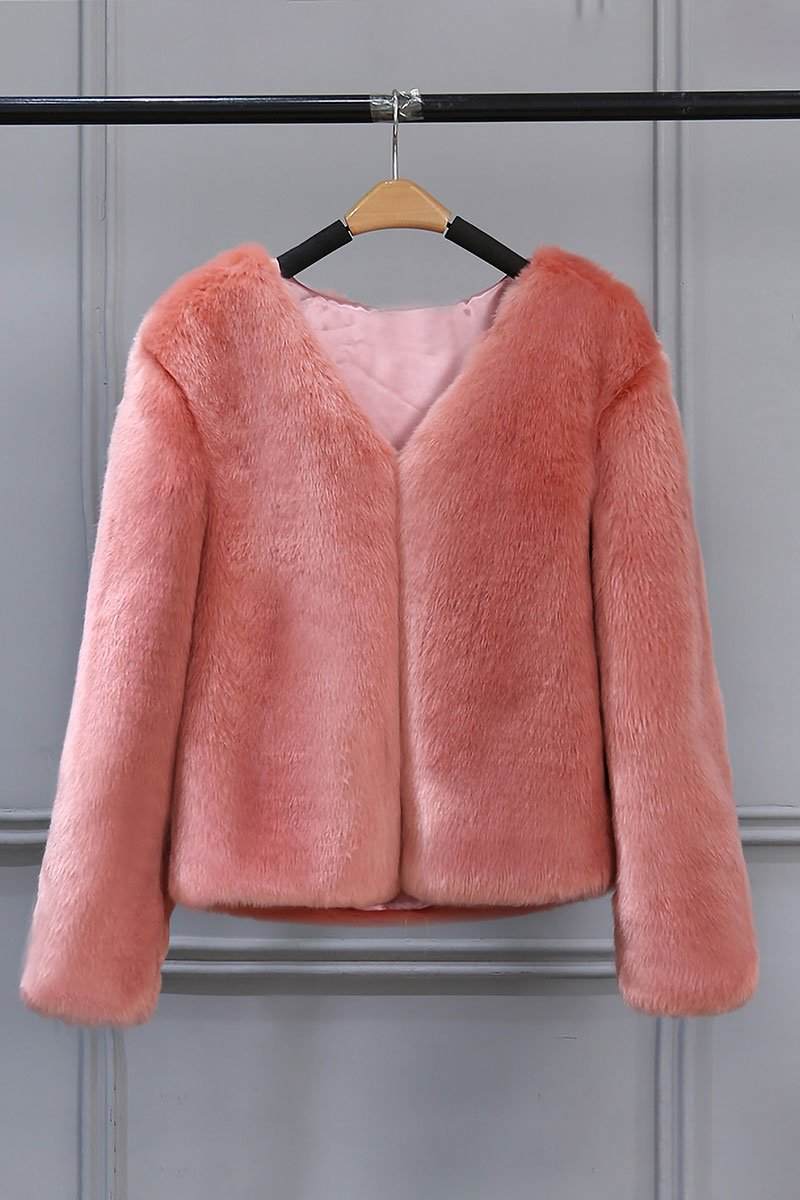 Pink bold faux fur jacket with V neckline and button front closure hanging on wooden hanger