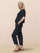 Woman wearing relaxed 100% cotton linen set with monochrome short-sleeve top and straight-leg pants