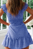 Back view of woman wearing blue sweetheart collar printed ruffled maxi dress with short ruffled sleeves and high waist design