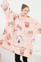 Woman wearing snuggly oversized hooded fleece sweater with pink sushi cartoon print