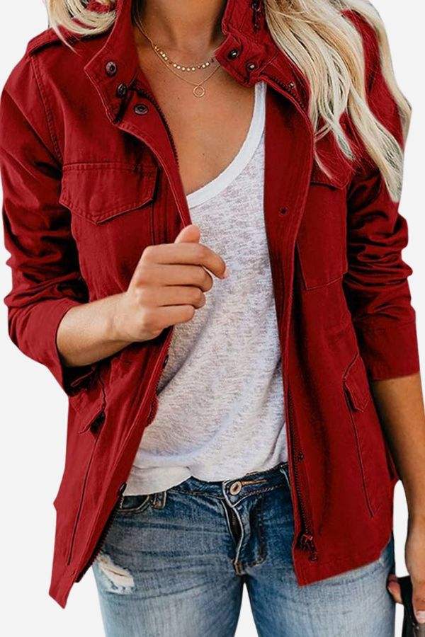 Woman wearing red fashion cargo utility jacket with multiple pockets and adjustable waist over white t-shirt and denim jeans