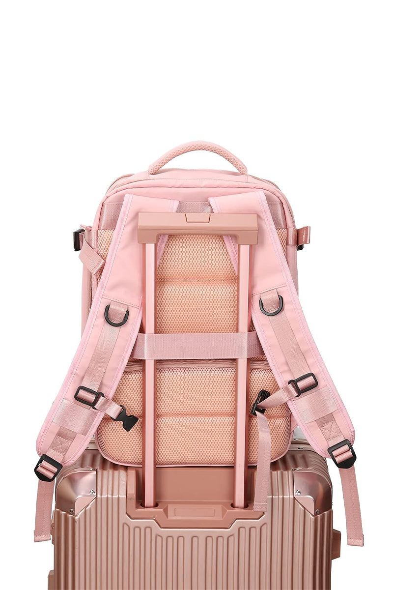 Chic Wanderlust Waterproof Backpack in pink shown attached to suitcase handle with padded ergonomic straps and breathable back panel.