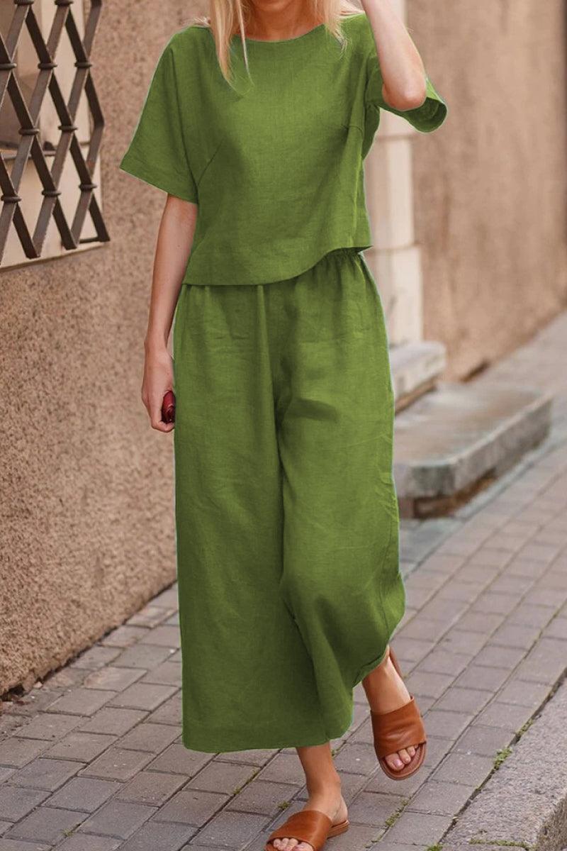 Woman wearing relaxed green loose fit co-ord set with wide-leg pants walking outdoors