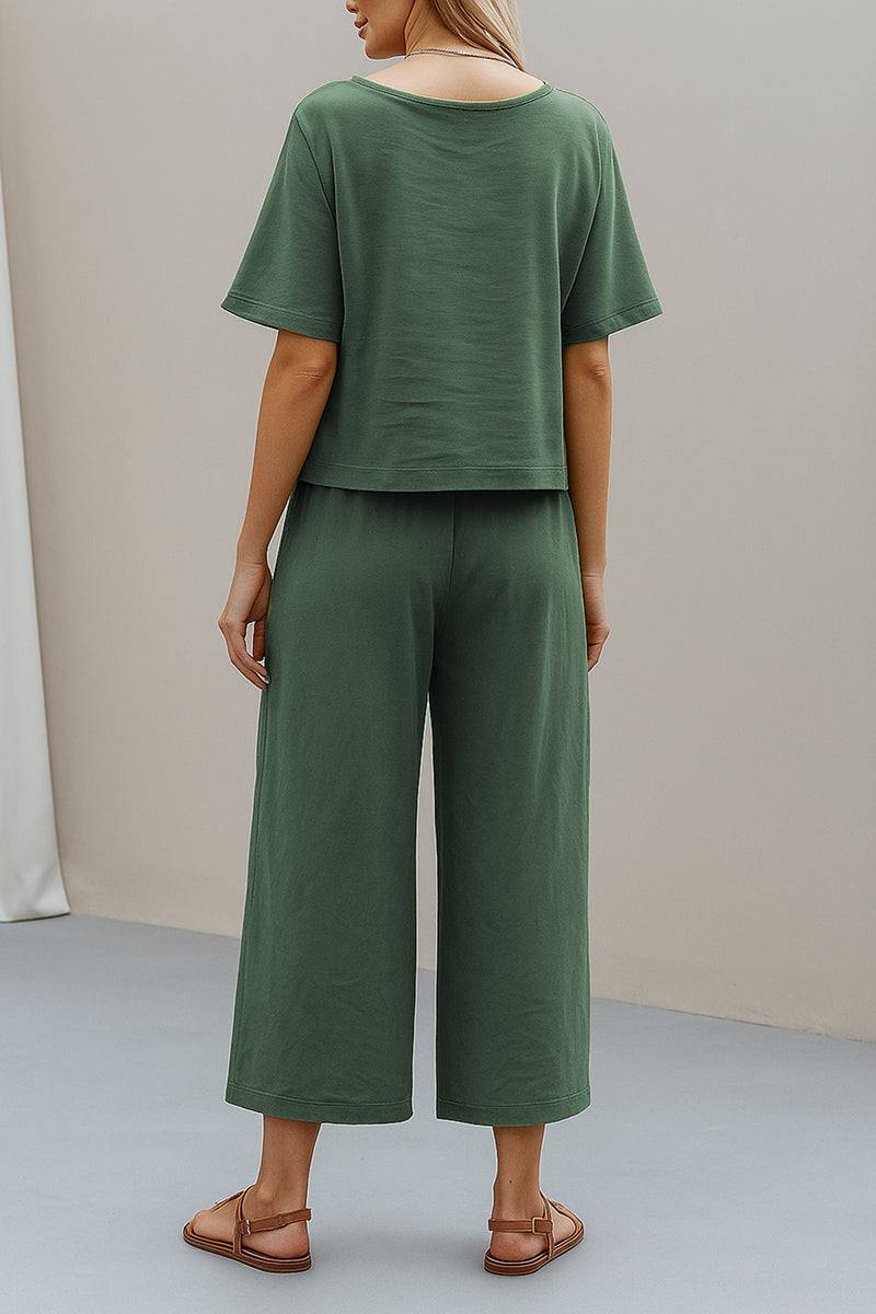 Woman wearing green loose fit co-ord set with short sleeves and wide-leg pants viewed from the back