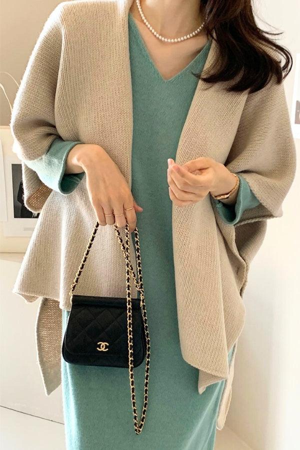Relaxed flowy open front knitwear cardigan in beige, styled with a green dress and black chain handbag for effortless, year-round comfort and flattering fit