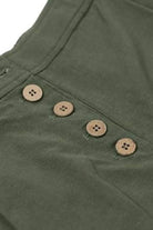 close-up of green button front high waist palazzo pants with four brown buttons