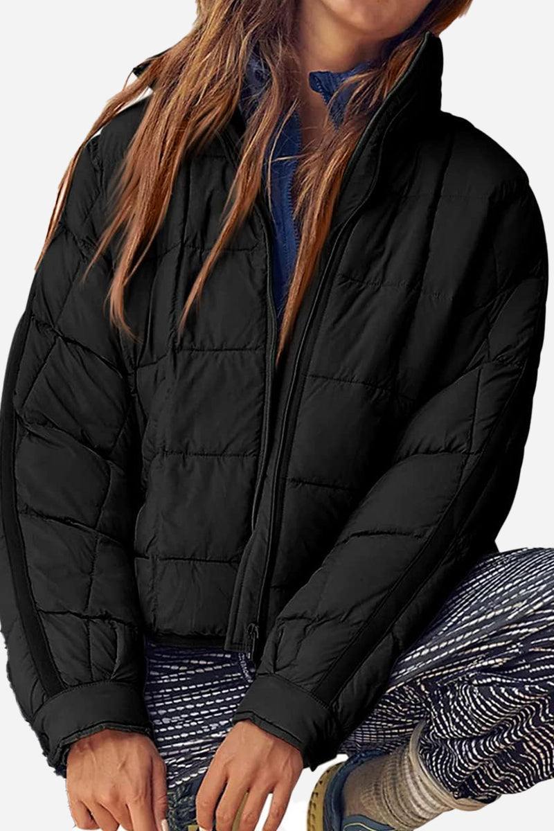 Lightweight puffer travel jacket packed flat for easy packing and travel convenience
