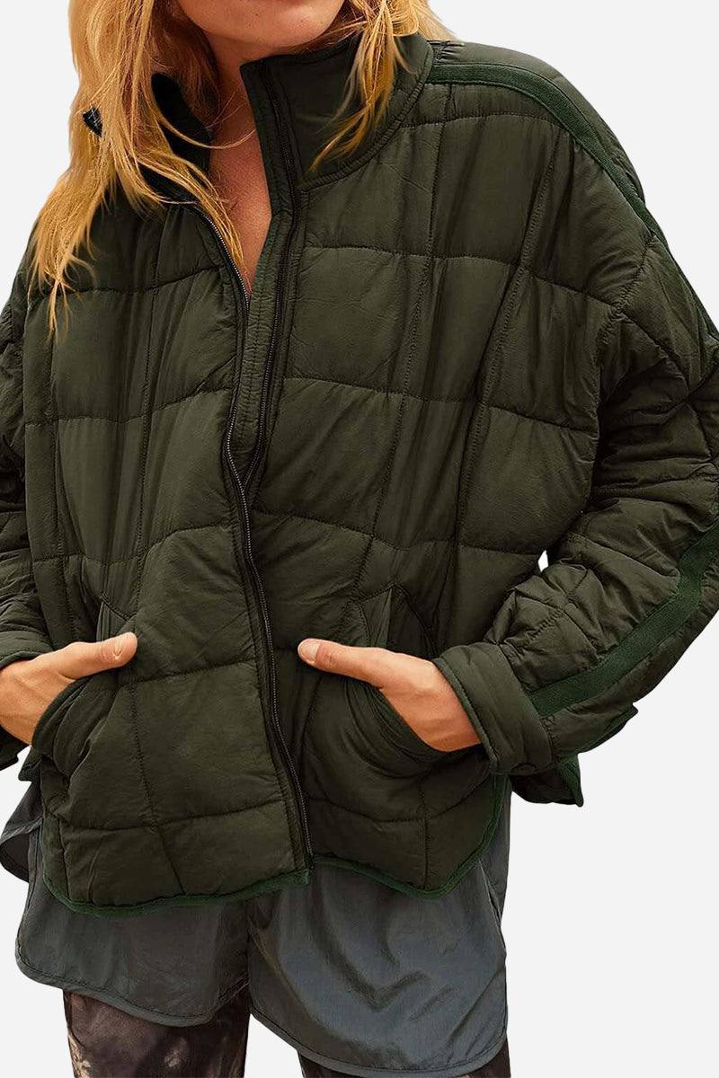woman wearing lightweight puffer travel jacket and backpack walking in nature outdoors