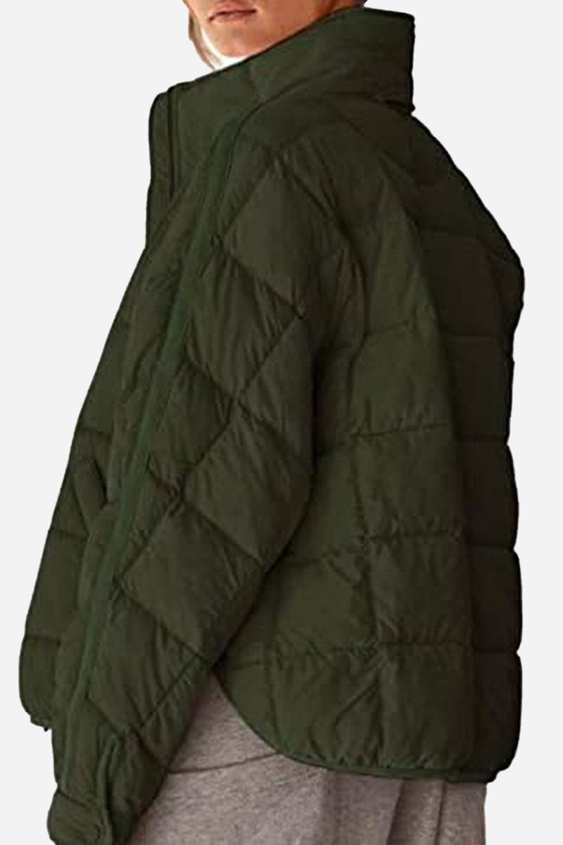Lightweight puffer travel jacket in black with sleek design for versatile and packable warmth