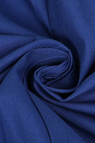 Close-up of blue premium fabric for sleeveless wide-leg jumpsuit showing silky texture and durability