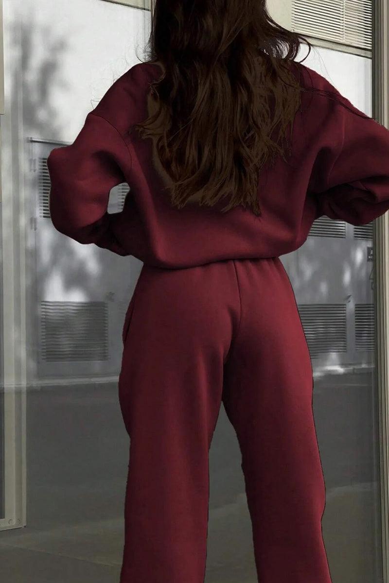 Woman wearing maroon cotton-blended two-piece tracksuit from the back outdoors