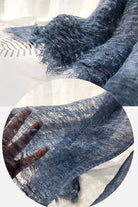 Close-up of lightweight blue linen scarf with frayed edges showing breathable fabric texture