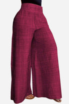 High waist wide leg pants in textured burgundy fabric with relaxed fit and elastic waistband