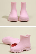 Pink non-slip rain boots with SuperGrip soles and waterproof design.