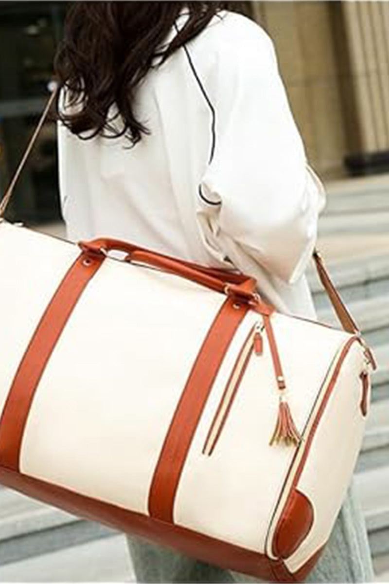 White and brown leather no-wrinkle foldable travel bag with shoulder strap carried by a woman