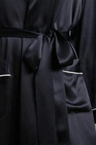 Close-up of black Mulberry Silk Nightgown with sash belt and pockets detailing
