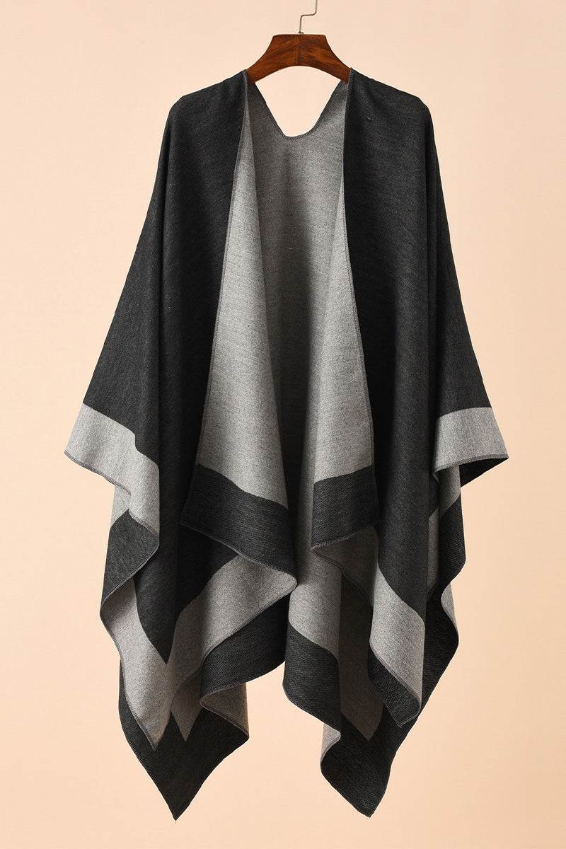 Elegant knitted poncho in two-tone black and gray with flowing silhouette and lightweight polyester knit design