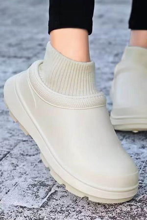 Lightweight waterproof fleece-lined comfort clogs with durable rubber sole and slip-on design for all-weather wear