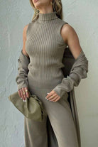 Elegant taupe ribbed sleeveless top, matching wide-leg pants, and long cardigan three-piece collection outfit with clutch bag.