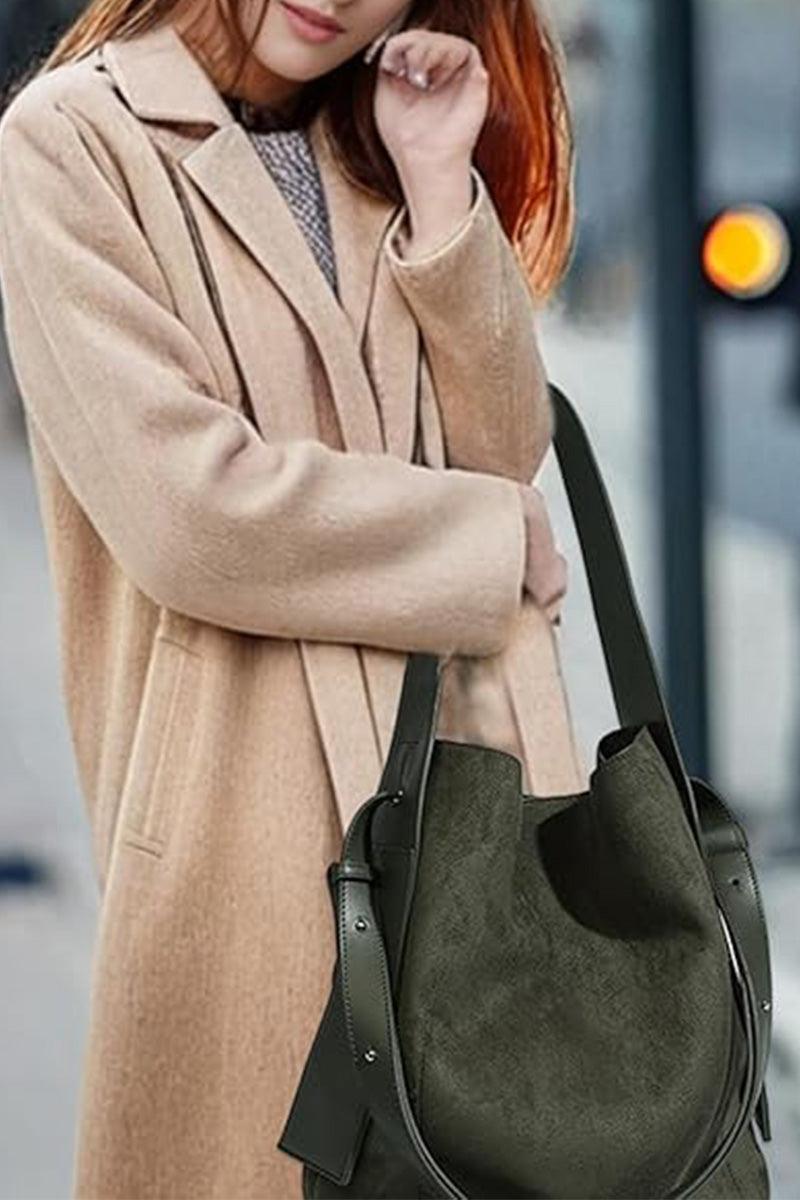 woman carrying vintage charm bag in suede with dual-length straps and spacious design