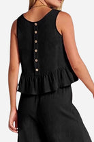Women's black linen-like feel set sleeveless top with buttons and ruffle hem paired with matching pants back view